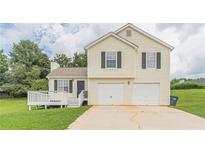 Charming two-story home with a two-car garage and a small deck at 341 Brookside Dr, Mcdonough, GA 30253