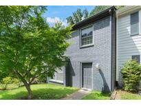 Gray painted brick home with front lawn and mature tree at 1731 Twin Brooks Se Dr, Marietta, GA 30067