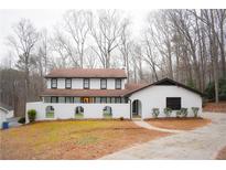 Charming white two-story home featuring black trimmed windows and manicured front yard at 2085 High Point Sw Trl, Atlanta, GA 30331