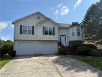 Split level home with two-car garage, dormer window, and classic design at 380 Paper Mill Rd, Lawrenceville, GA 30046