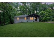 Charming home showcasing a freshly manicured front yard and modern exterior design at 1733 Hollyhock Ter, Decatur, GA 30032