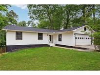 Charming single story home with an attached garage, manicured lawn and fresh landscaping at 383 Oakridge Dr, Cartersville, GA 30121