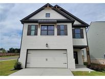 Charming two-story home with painted brick, garage, and dark accents at 11 Butternut Way, Auburn, GA 30011
