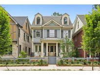 Charming two-story home with a landscaped yard, dormer windows, and a welcoming front porch at 105 Cumming St, Alpharetta, GA 30009