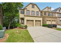 Charming two-story home with a two-car garage and beautifully landscaped front yard at 1636 Caswell Pkwy, Marietta, GA 30060