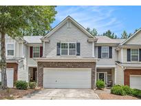 Charming two-story home features a two-car garage, brick accents, and meticulous landscaping at 461 Mountain View Ln, Woodstock, GA 30188