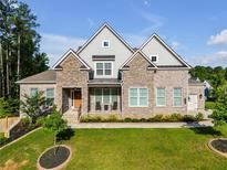 Charming two-story home featuring a landscaped front yard and a mix of stone and brick exterior at , Kennesaw, GA 30152
