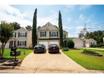 Charming two-story home with a well-manicured lawn, driveway, and beautiful landscaping, showcasing curb appeal at 1312 Glenover Way, Marietta, GA 30062