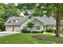 Charming home with a two-car garage, manicured lawn, and lush landscaping provides great curb appeal at 17 Sassafras Ne Trl, Cartersville, GA 30121