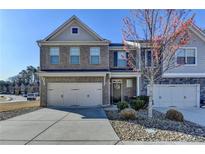 Two-story brick and siding home with a two-car garage and manicured front yard at 2639 Cooper Brook Dr, Snellville, GA 30078