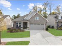 Charming, single-story brick home featuring a well-manicured lawn and a two-car garage at 218 Floral Valley Dr, Woodstock, GA 30188