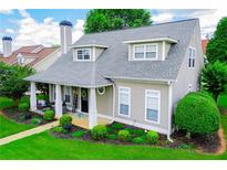 Charming home featuring a welcoming front porch, complemented by a lush green lawn and well-maintained landscaping at 2763 Nautical Way, Villa Rica, GA 30180