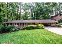 Charming brick ranch home with a lush front lawn and mature trees offering curb appeal at 2518 Foster Ridge Ne Ct, Atlanta, GA 30345