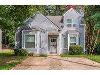 Charming home featuring a two-story facade, gray siding, bay windows, and a concrete driveway at 620 Waynes Se Ct, Atlanta, GA 30354
