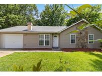 Charming single-story home with a stone accent, attached garage and well-maintained front lawn at 924 Sweetwater Cir, Lawrenceville, GA 30044