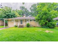 Charming single-story home with a covered front porch and a green lawn, perfect for outdoor enjoyment at 3409 Hyland Dr, Decatur, GA 30032
