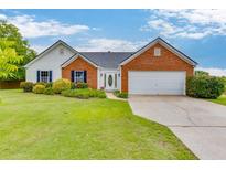 Charming single-story home with brick accents and a well-manicured front yard at 4735 Widgeon Way, Cumming, GA 30028