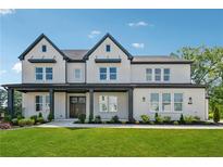 Beautiful two-story home features a well-manicured lawn, inviting front porch, and classic design elements at 7420 Wild Violet Dr, Cumming, GA 30040