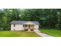 Charming single-story home with a cozy front porch and a driveway in a lush, wooded setting at 2128 Kimberly Rd, Atlanta, GA 30331