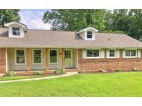 Charming single-story home with brick accents, dormer windows, and a well-manicured lawn at 5254 Corinth Dr, Stone Mountain, GA 30087