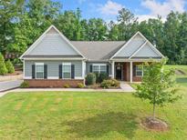Charming single-story home with well-manicured lawn and inviting entryway at 110 Collingwood Lndg, Covington, GA 30016