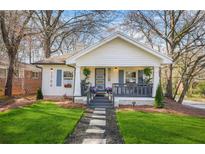 Charming home with a welcoming front porch, landscaped lawn, and stylish blue accents at 1766 Ware Ave, Atlanta, GA 30344