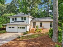 Charming two-story home with white siding, a two-car garage, and a wooden porch at 4363 Old Mabry Road Northeast Ne Rd, Roswell, GA 30075