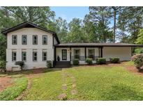 Charming two-story home featuring a welcoming front yard, black accents, and well-maintained landscaping at 3480 Tanbark Ne Ct, Brookhaven, GA 30319