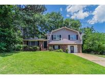 Charming home featuring a well-maintained lawn and beautiful mature trees offering nice shade at 6708 Bedford Rd, Rex, GA 30273