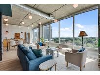 Bright living room with modern decor and large windows offering city views at 943 Peachtree Ne St # 814, Atlanta, GA 30309