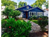 Charming blue home featuring a stone walkway, well-maintained landscaping, and inviting curb appeal at 1190 Francis Nw St, Atlanta, GA 30318