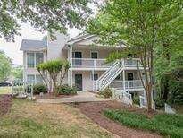 Exterior of a two-story home with stairs leading to the entrance with natural light and landscaping at 108 Countryside Se Pl, Smyrna, GA 30080