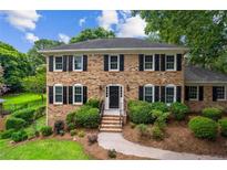 Traditional brick home featuring black shutters and mature landscaping at 3013 Huntshire, Doraville, GA 30340