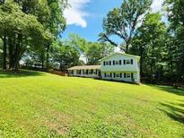 Charming home with a sprawling front yard and mature trees, offering a serene and private setting at 4798 Mary Dale Ct, Lilburn, GA 30047