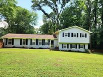 Traditional two-story home with a well-manicured front yard and mature trees at 4798 Mary Dale Ct, Lilburn, GA 30047
