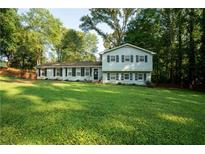 Charming two-story home with black shutters and a spacious front yard at 4798 Marydale Sw Ct, Lilburn, GA 30047
