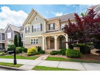 Charming two-story home with stone accents, a covered front porch, and mature landscaping at 238 Avery Ne St, Marietta, GA 30060