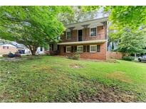 Charming two-story brick home with a second-floor balcony and a spacious front yard at 2711 Bethesda Ne Ct, Lawrenceville, GA 30044