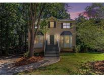 Charming two-story brick home with bay windows, fresh landscaping, and a welcoming staircase at 3440 Oaktree Way, Stonecrest, GA 30038