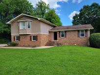 Charming brick home with a well-maintained lawn and inviting curb appeal at 2206 Rhett Ct, Lawrenceville, GA 30044