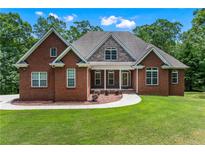 Beautiful brick home featuring manicured lawn and complementing stone accents at 6020 Cochran Mill Rd, Palmetto, GA 30268