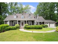 Charming home with a manicured lawn, inviting front porch, and a two-car garage at 3561 Stone Dr, Marietta, GA 30062