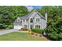 Charming gray two-story home with well-manicured lawn and lush landscaping at 681 Braidwood Nw Ter, Acworth, GA 30101