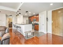 Well-lit kitchen features a breakfast bar, stainless steel appliances, and wood cabinets at 171 Auburn Ne Ave # 521, Atlanta, GA 30303