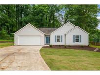 Charming single-story home with white siding, blue shutters, and well-manicured lawn at 2109 Tranquility Ct, Woodstock, GA 30188
