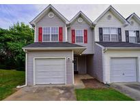 Charming townhome featuring attached garages, gray siding, and symmetrical window design at 6927 Gallant Se Cir # 11, Mableton, GA 30126