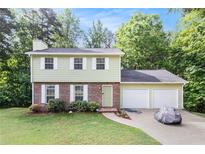 Charming two-story home with attached two-car garage and well-maintained lawn at 2722 Spring Side Ct, Douglasville, GA 30135