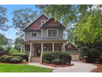 Charming two-story home with a covered front porch and beautifully landscaped front yard at 47 Oakridge Se Ave, Atlanta, GA 30317
