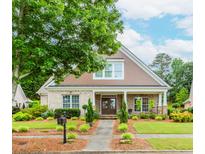 Charming, brick home featuring manicured landscaping, a walkway, and a welcoming front porch at 2727 Bearcreek Pl, Buford, GA 30519