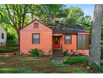 Charming single-story home with a landscaped front yard and colorful exterior at 1776 Fairway Hill Se Dr, Atlanta, GA 30317